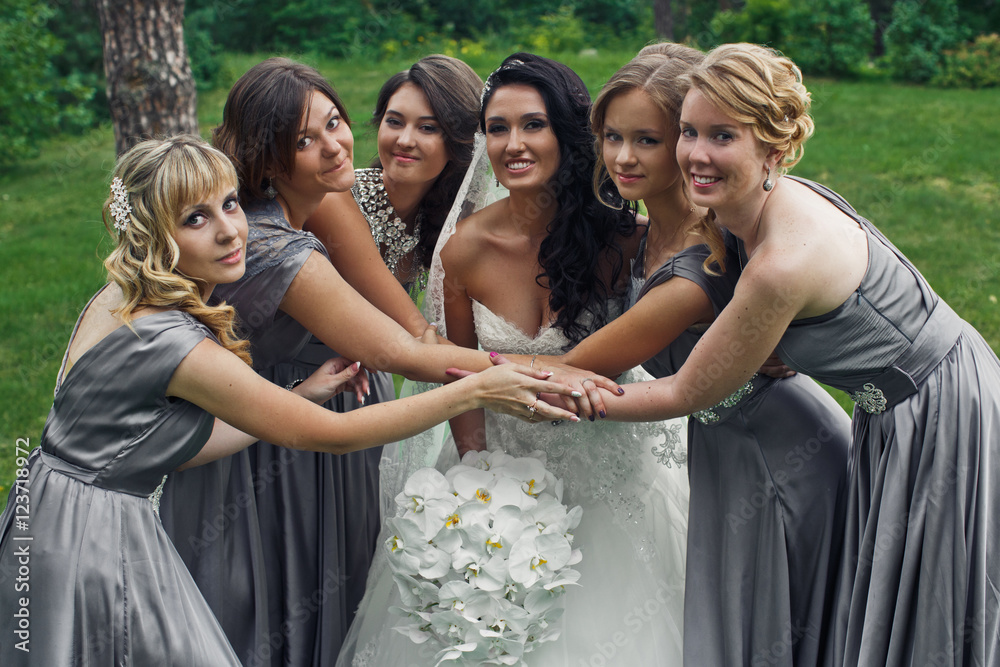 The happiness bride with bridesmaids  in the park