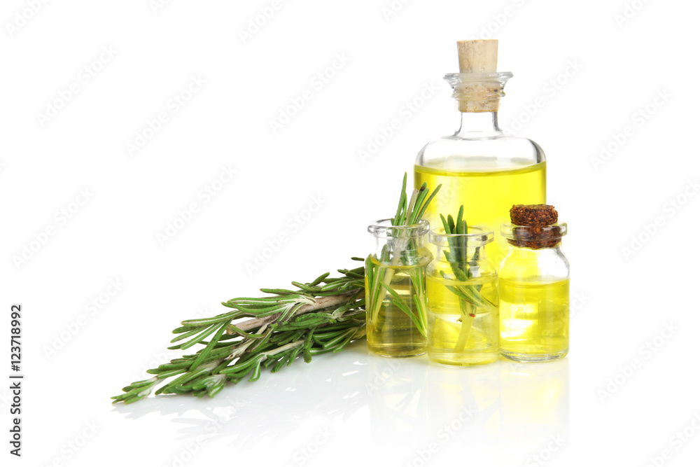 Bottles of coniferous essential oil and rosemary branch isolated on white Bottles of coniferous essential oil and rosemary branch isolated on white