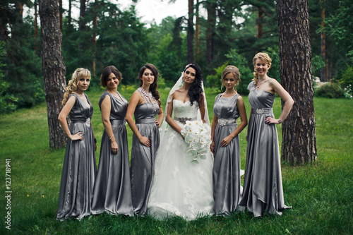 The tenderness bride with bridesmaids  in the park © nastasenko