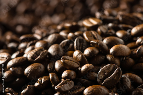 Fotografie, Obraz Sea of dark roasted coffee beans flowing into background