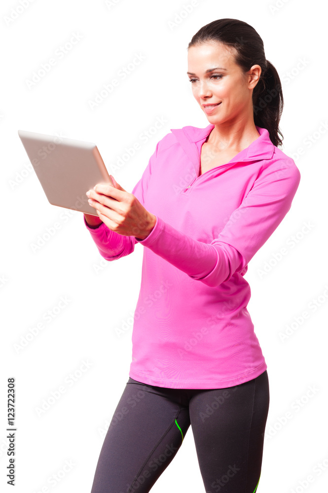 Fit young woman in sports clothing with digital tablet computer isolated on white background Fit young woman in sports clothing with digital tablet computer isolated on white background