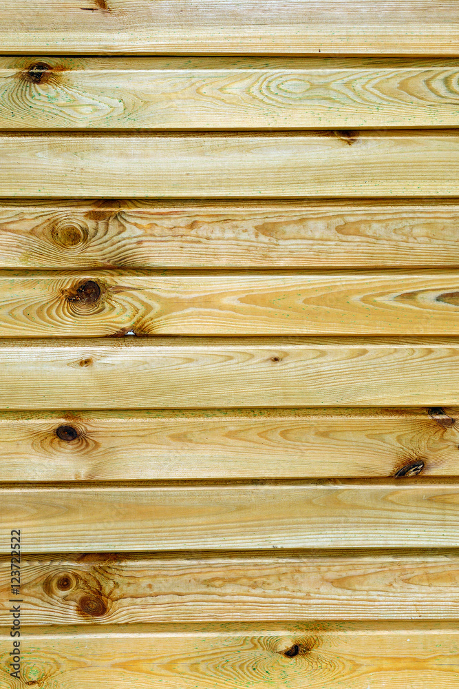 Closeup of a rustic wall built with natural wood planks