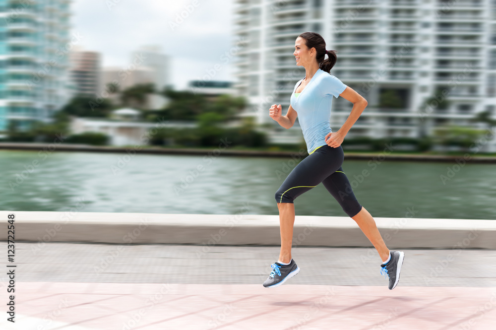 Young woman running jogging near water in downtown Miami