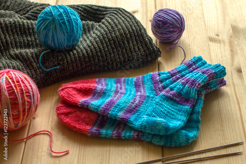 Three different colored wool skeins, knitted socks handmade