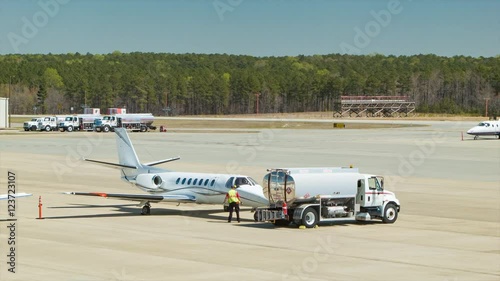 Generic Business Jet Refueled by Jet Fuel Gas Truck at the Raleigh-Durham International RDU Airport Private Aviation Platform on a Sunny Day in the Research Triangle North Carolina