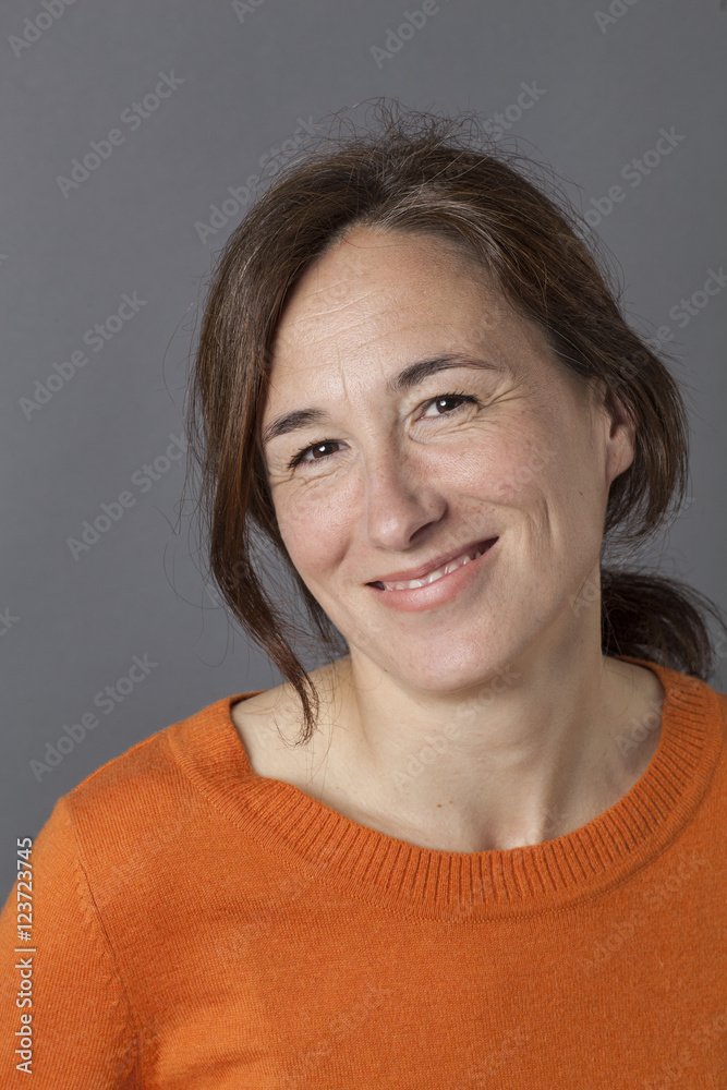 natural, gorgeous middle aged woman smiling for serenity and wellness