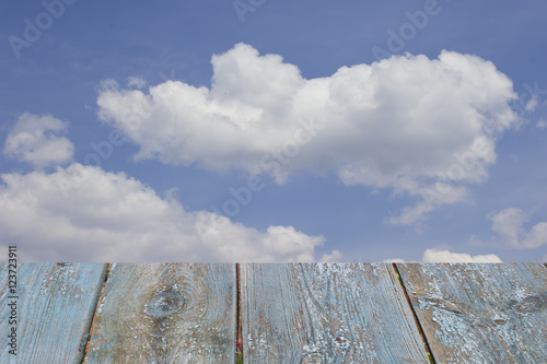 empty wooden table on the sky background .
