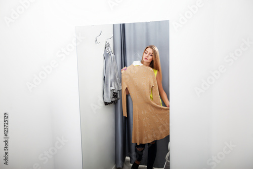 Woman with dress in the checkroom