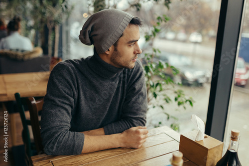 Image of handsome young man in restaurant