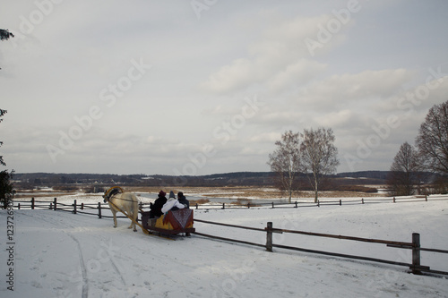 People on a carriage ride around the snowed field