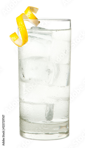 Highball vodka tonic or soda alcoholic cocktail with lemon twist isolated on white background