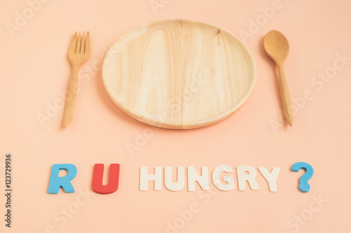 Are you hungry text with wooden plate and cutlery