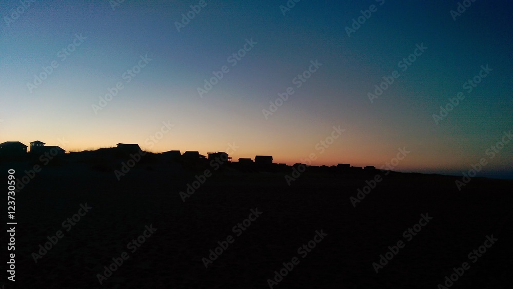 Sunset over houses at the beach Sunset over houses at the beach