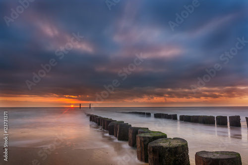 Sun sets in the sea after a storm