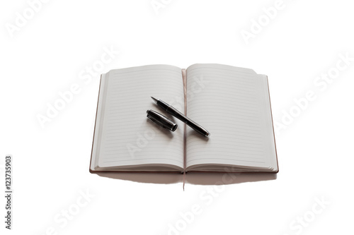 Pen on top of brown agenda with white background