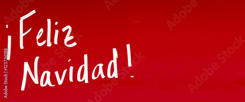 Postcard for Christmas time handwritten "Merry Christmas" whishes in spanish "feliz navidad"