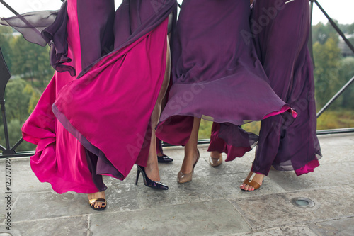 Pink and purple dresses of the bridesmaids