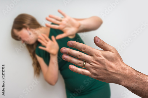 Woman covering her face - domestic violence concept