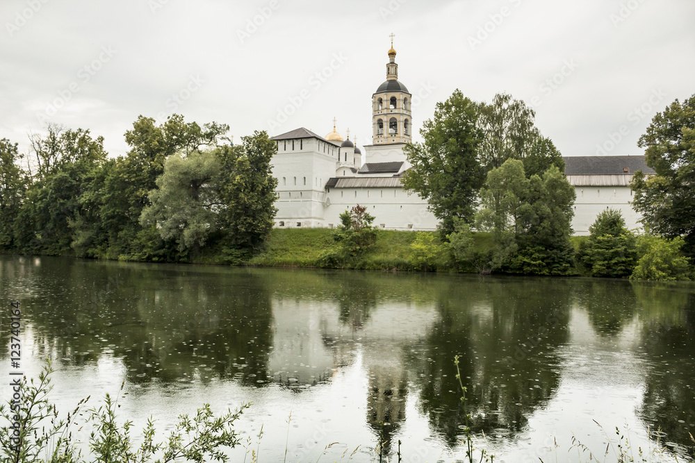 Orthodox monastery in the town of Borovsk near Moscow.	Fortress tower and wall , the bell tower on the shore of the pond.