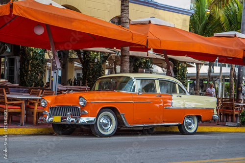 Photography Vintage orange car parked at Ocean Drive in Miami Beach, Florida