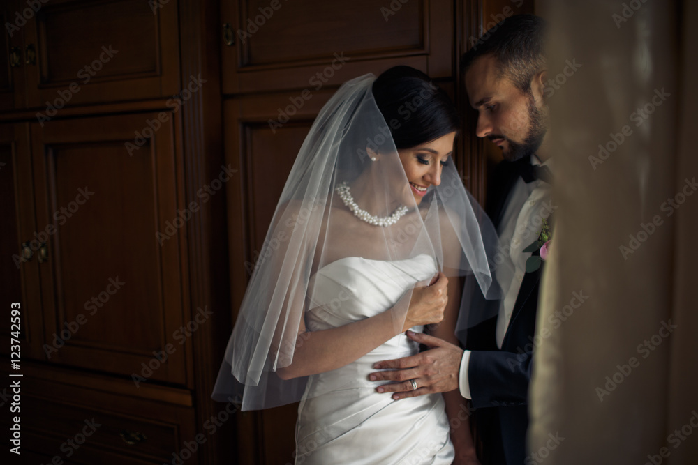The lovely brides stand  in the room