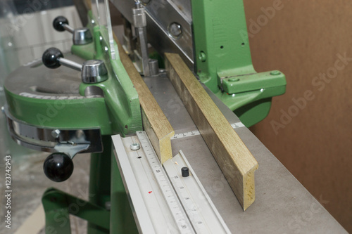 Craftsman working on frame in frameshop. © nagornyi