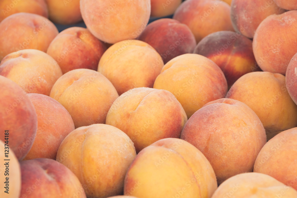 View close-up of fresh peaches. Juicy peaches. A lot of peaches. Heap of peaches. Summer tray market agriculture farm full organic peaches. Fruit peaches background (selective focus) View close-up of fresh peaches. Juicy peaches. A lot of peaches. Heap of peaches. Summer tray market agriculture farm full organic peaches. Fruit peaches background (selective focus)