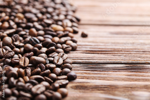 Roasted coffee beans on a brown wooden table