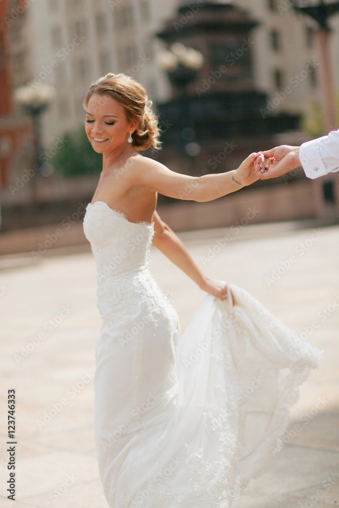 Charming smile of the bride in the wedding dress