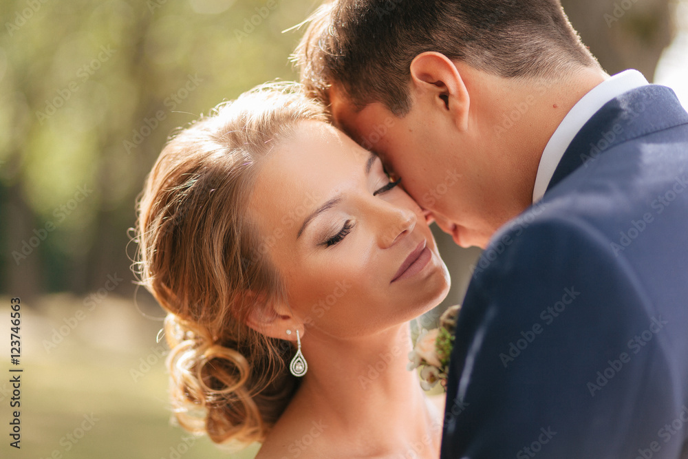 Nice bride in the embracement of her groom Nice bride in the embracement of her groom