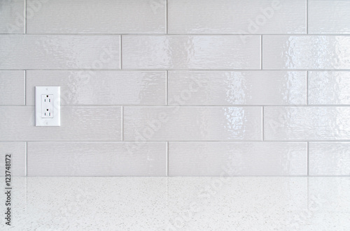 Modern kitchen granite countertop  against gray ceramic backspla