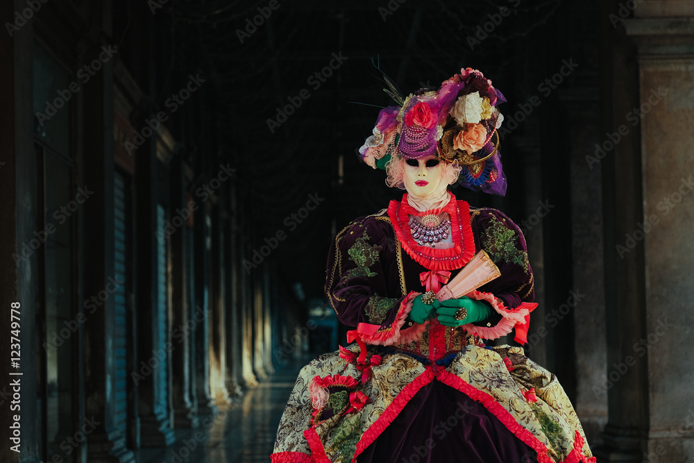 A shot of a lady in colored carnival dress standing in the front A shot of a lady in colored carnival dress standing in the front