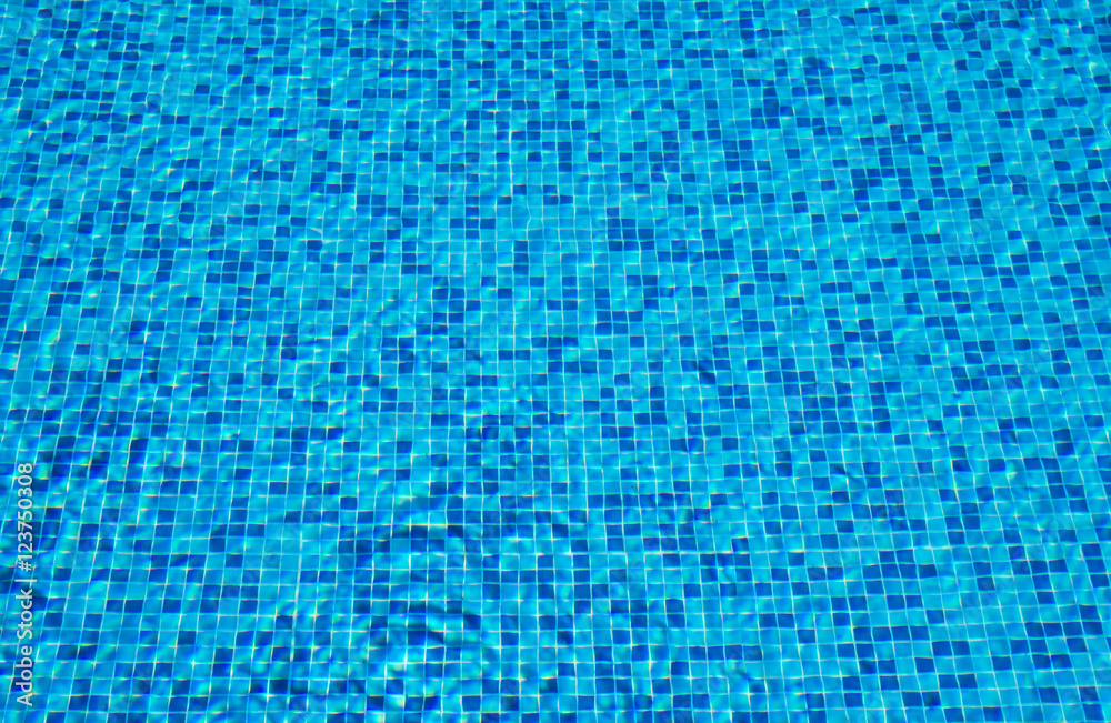 Background of a blue tiled pool with clear cool rippling water Background of a blue tiled pool with clear cool rippling water