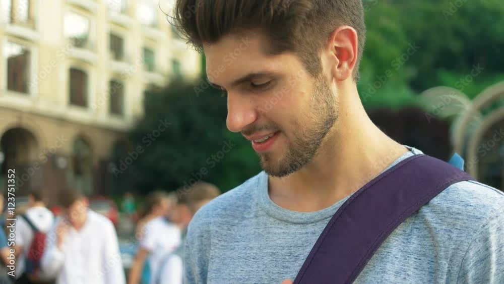 Tourist using his phone in the center of a city. Tourist using his phone in the center of a city.