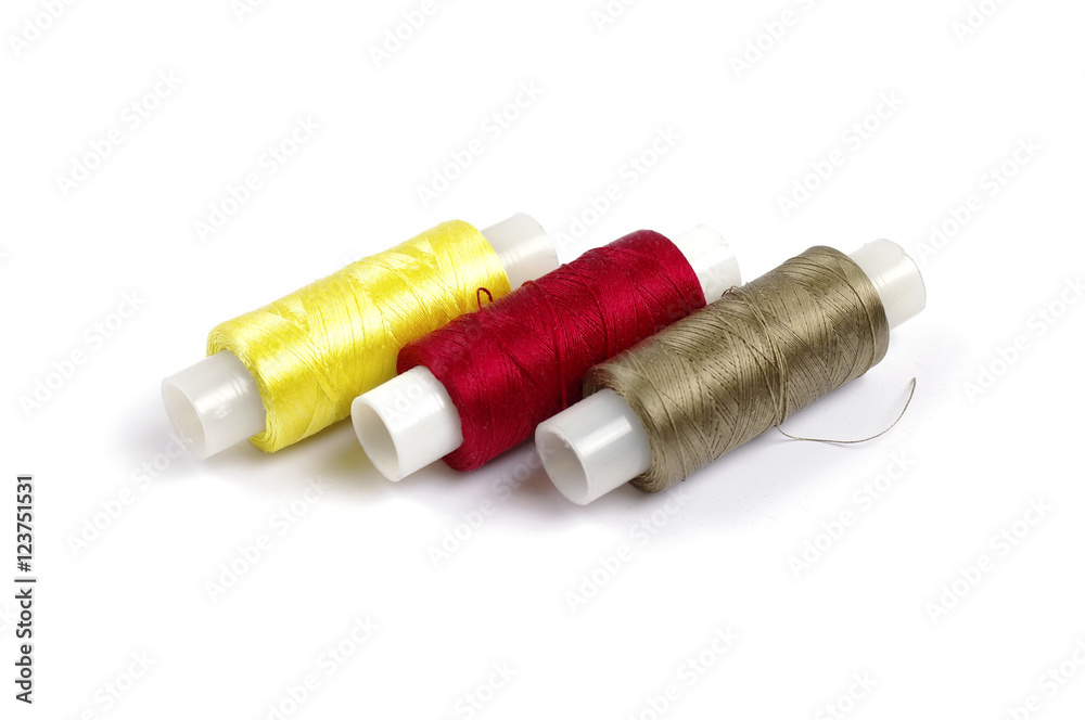 Spools of multicolored silk threads on white background Spools of multicolored silk threads on white background