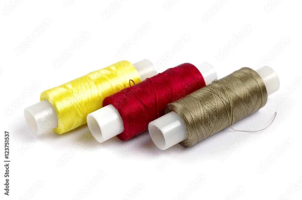 Spools of multicolored silk threads on white background Spools of multicolored silk threads on white background