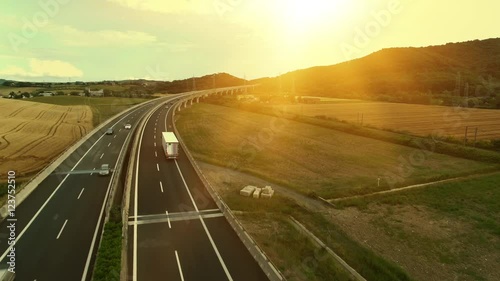 Aerial Shot of Truck on Highway in Rural Area in Sunset Light