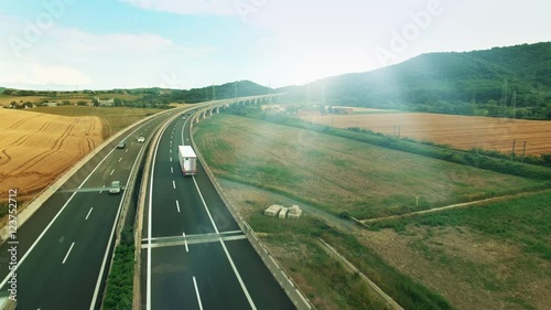 Aerial Shot of Truck on Highway in Rural Area in Sunset Light