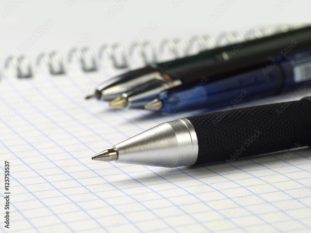 set of ballpoint pen on open spiral notebook, macro, shallow depth of field set of ballpoint pen on open spiral notebook, macro, shallow depth of field