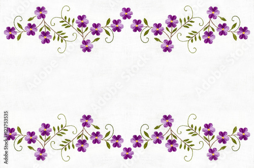 Border from violet flowers and leaf embroidered satin stitch on white background
