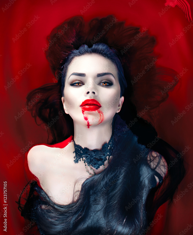 Halloween. Sexy vampire woman lying in a bath full of blood Stock Photo ...