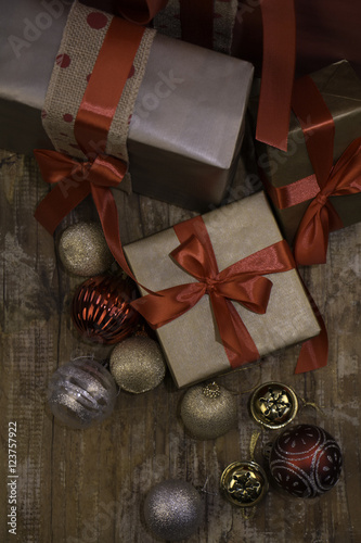 Christmas presents and baubles on a wooden background