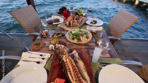 Turkish table with sea products, traditional alcoholic beverage Raki and meze photo