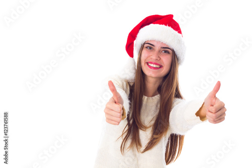 Woman in red christmas hat showing thumbs up