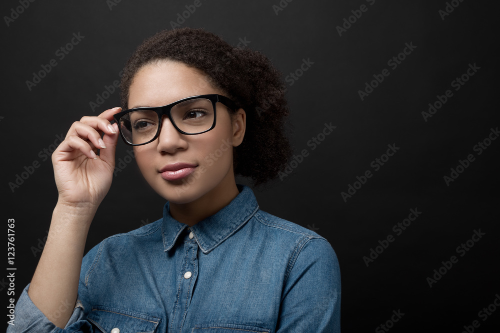 Portrait of stylish young woman with brown hair. Shot on a black background. Portrait of stylish young woman with brown hair. Shot on a black background.