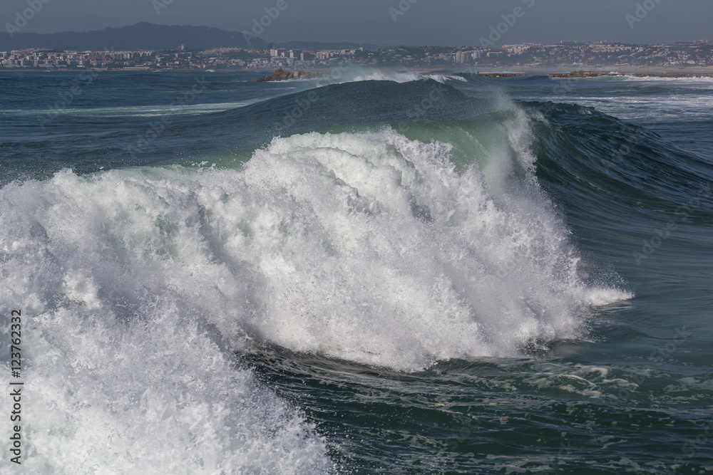 Ocean waves in Costa da Caparica. Autumn day in Almada, Portugal.
