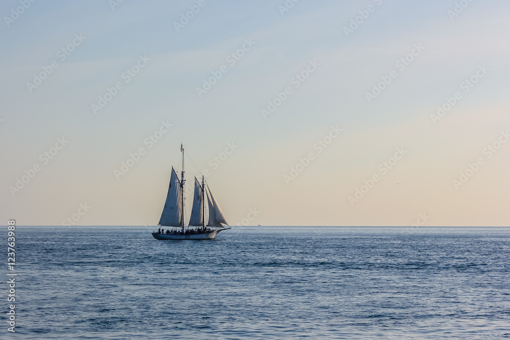 Sailing ship in the Atlantic Ocean at sunset, Key West, Florida Keys, Florida, United States. The boats for the Sunset Celebration starts from Mallory Square. Sunset Sailing in Key West Florida