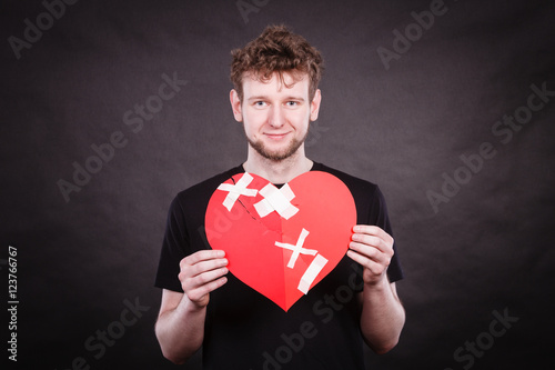 Happy man with plaster heart. photo