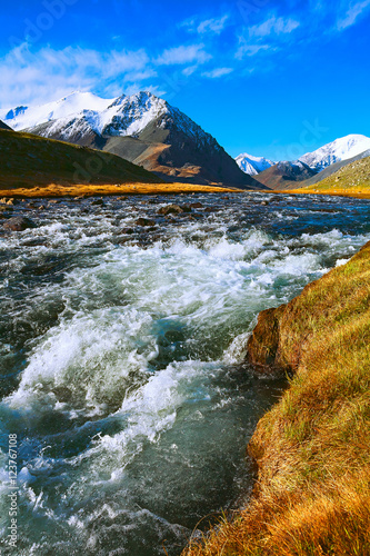 autumn landscape mountain river with rapid current of water flow