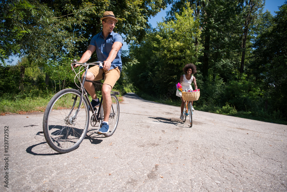 Fototapeta premium Young multiethnic couple having a bike ride in nature